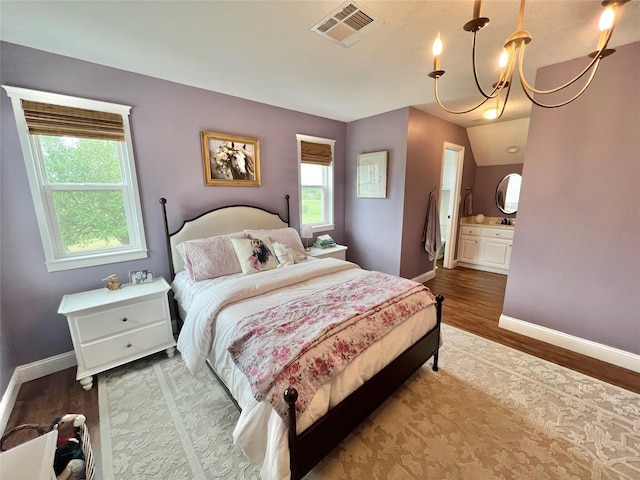bedroom featuring baseboards, visible vents, and multiple windows