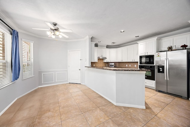 2634 Couch St, Houston, TX 77008 - kitchen featuring black appliances, light tile patterned floors, ceiling fan, white cabinets, and a peninsula