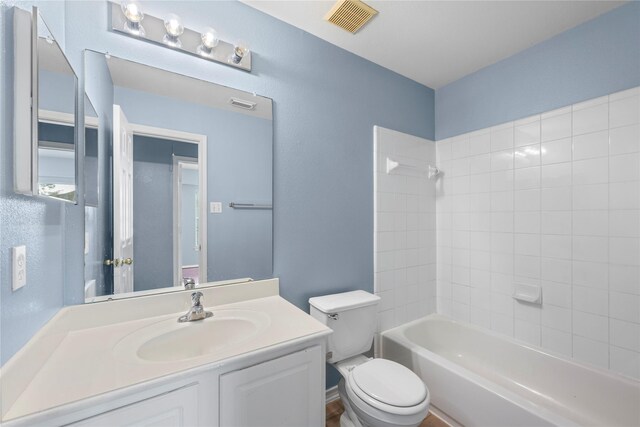 16854 Carrollton Creek Ln, Houston, TX 77084 - bathroom featuring visible vents, toilet, vanity, and shower / tub combination