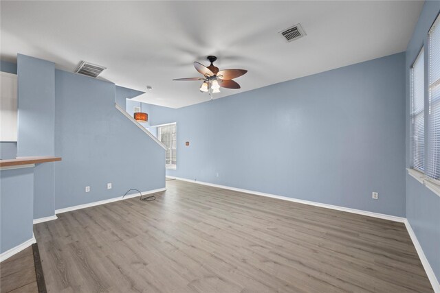 16854 Carrollton Creek Ln, Houston, TX 77084 - unfurnished living room with wood finished floors, baseboards, a ceiling fan, and visible vents