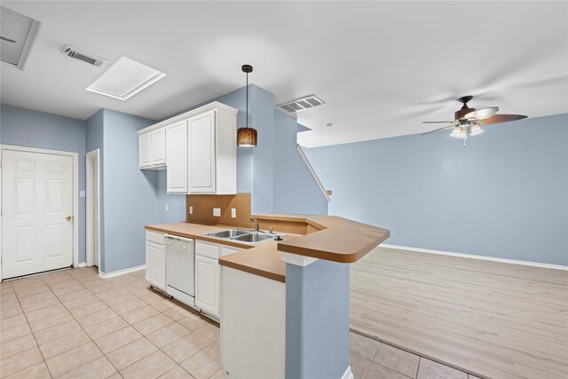16854 Carrollton Creek Ln, Houston, TX 77084 - kitchen featuring dishwasher, a peninsula, a sink, and visible vents
