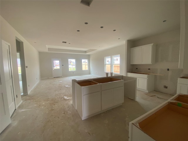 kitchen with open floor plan, white cabinetry, and a center island