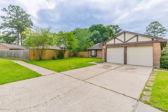 exterior space featuring concrete driveway, an attached garage, and fence