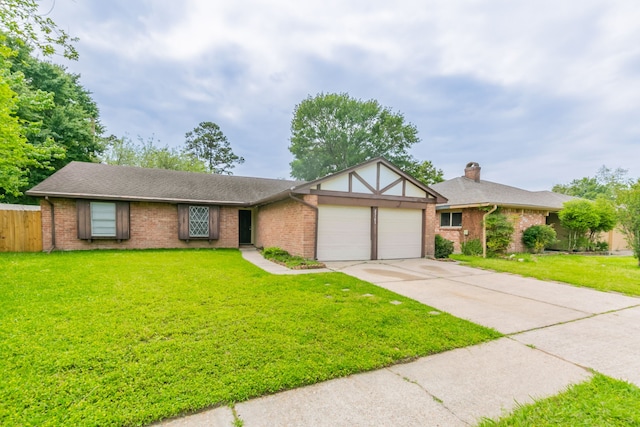 view of front of home featuring an attached garage, brick siding, driveway, and a front yard