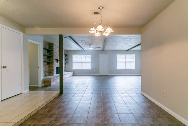 interior space with visible vents, beam ceiling, baseboards, a fireplace, and ceiling fan with notable chandelier