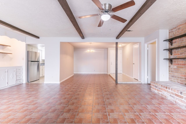 unfurnished living room with visible vents, baseboards, a textured ceiling, and beamed ceiling