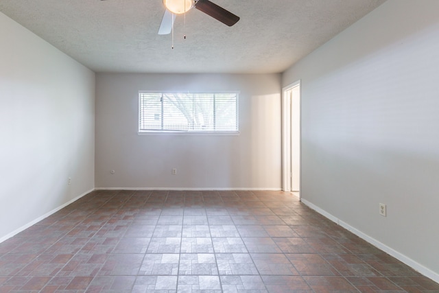 unfurnished room with ceiling fan, baseboards, and a textured ceiling