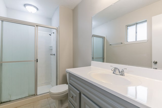 full bathroom with toilet, vanity, tile patterned flooring, and a stall shower