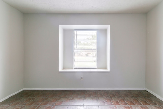 empty room featuring baseboards