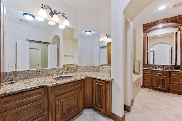 41411 Roundup Rd, Magnolia, TX 77354 - full bath featuring two vanities, a sink, tile patterned floors, and visible vents