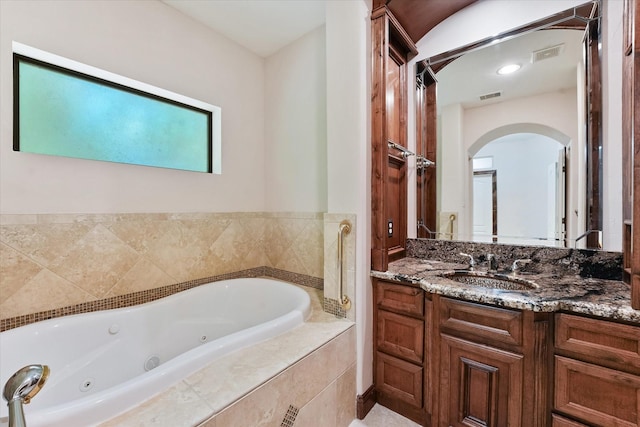 41411 Roundup Rd, Magnolia, TX 77354 - full bathroom featuring a whirlpool tub, visible vents, and vanity