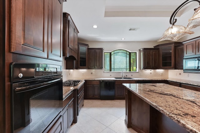 41411 Roundup Rd, Magnolia, TX 77354 - kitchen featuring visible vents, black appliances, dark brown cabinetry, and a sink