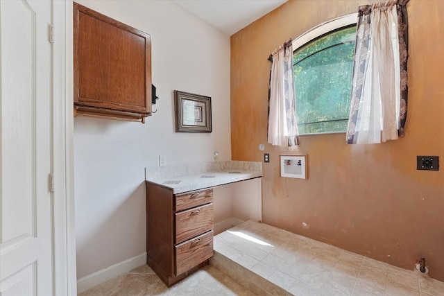 41411 Roundup Rd, Magnolia, TX 77354 - laundry area featuring hookup for a washing machine, light tile patterned floors, and cabinet space