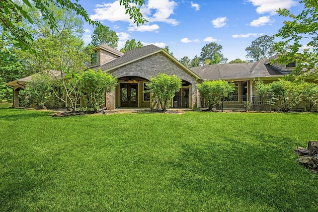 41411 Roundup Rd, Magnolia, TX 77354 - view of front of house featuring a front lawn, french doors, and roof with shingles