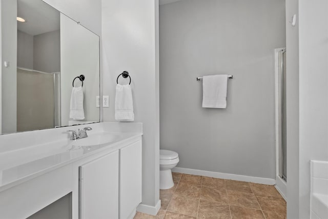 full bathroom featuring baseboards, vanity, toilet, and a stall shower