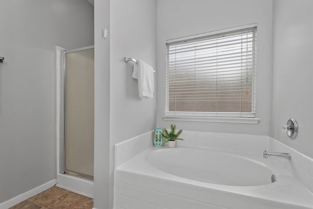 full bathroom featuring a bath and a stall shower