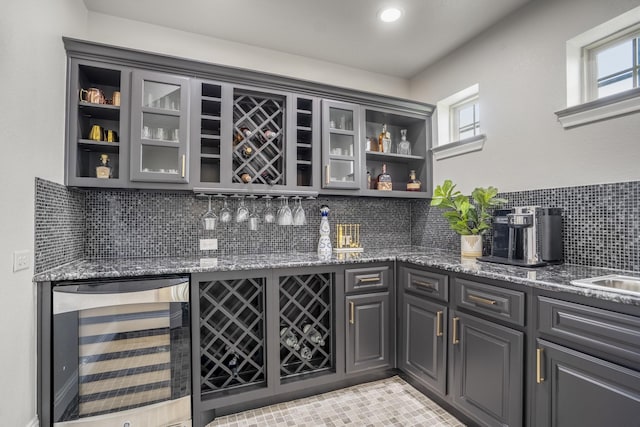 bar featuring plenty of natural light, a dry bar, and wine cooler