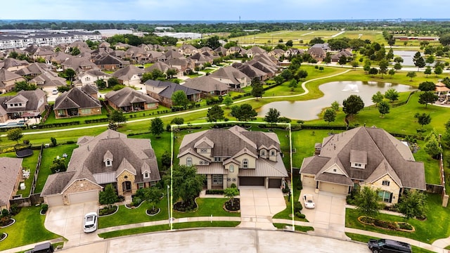 birds eye view of property with a water view and a residential view