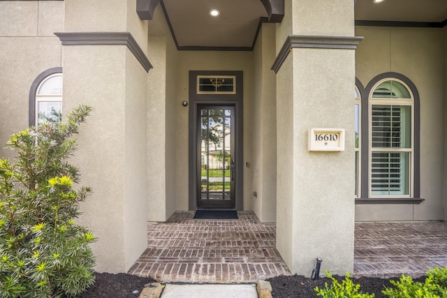 property entrance with stucco siding