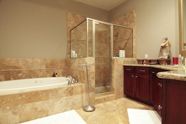 full bathroom featuring a garden tub, vanity, a shower stall, and ornamental molding