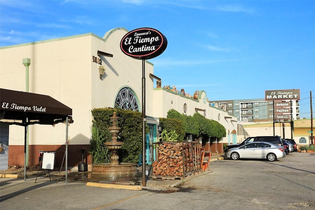 view of building exterior with uncovered parking