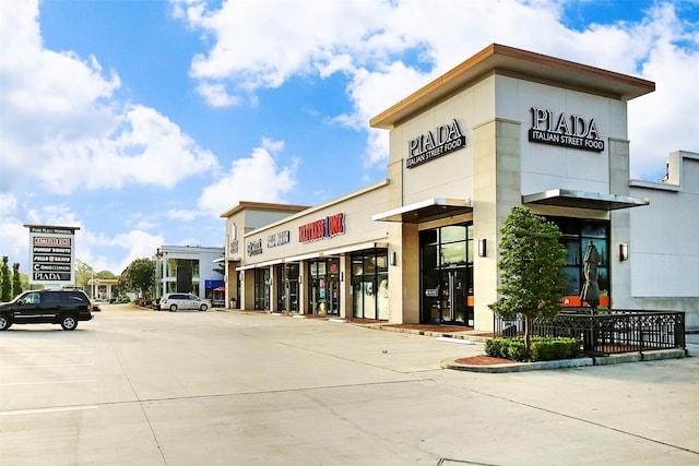 view of property with uncovered parking