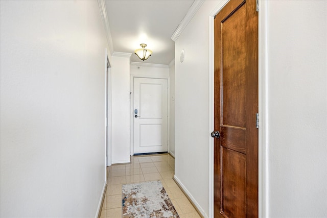 hallway featuring baseboards, ornamental molding, and light tile patterned floors