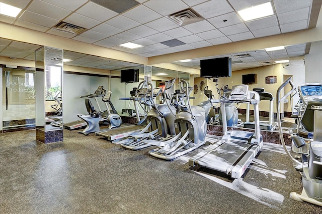 exercise room with visible vents and a drop ceiling