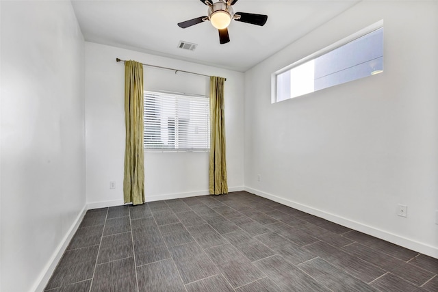 spare room with a ceiling fan, baseboards, and visible vents