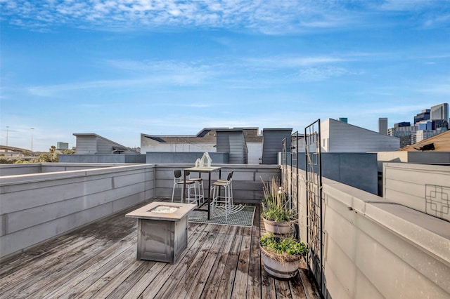 wooden deck featuring an outdoor fire pit