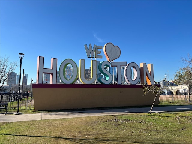 community / neighborhood sign with fence