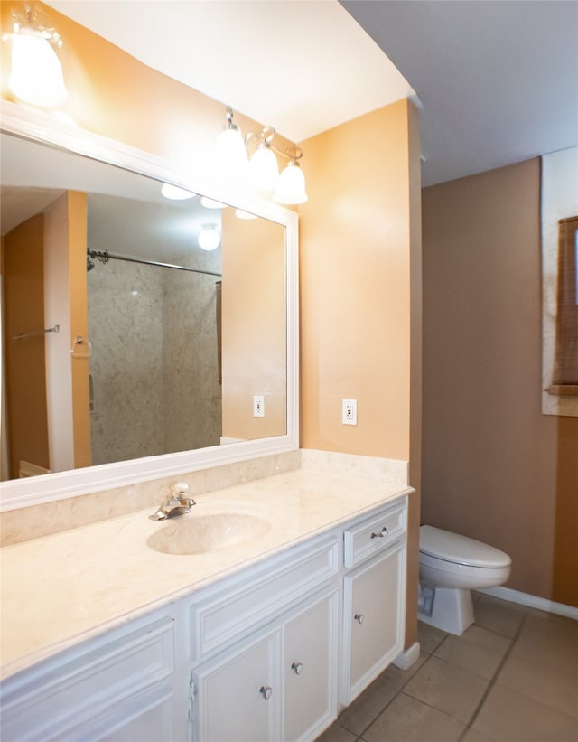 bathroom featuring tile patterned flooring, toilet, vanity, and a shower with curtain