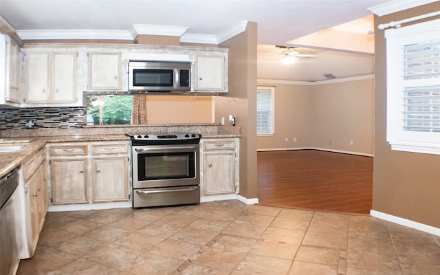 234 Fantasy Ln, Montgomery, TX 77356 - kitchen with stainless steel appliances, decorative backsplash, a ceiling fan, ornamental molding, and light stone countertops