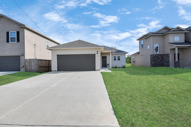 view of front of home with driveway, a front yard, fence, an attached garage, and a shingled roof