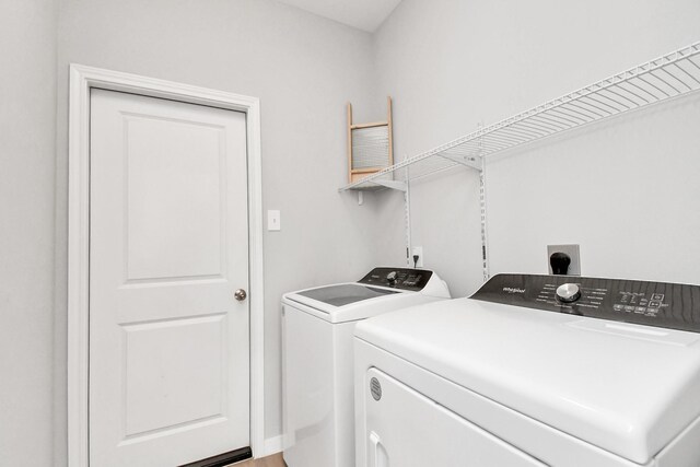 washroom with separate washer and dryer and laundry area