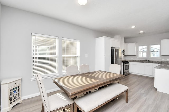 dining area with recessed lighting, baseboards, and light wood finished floors