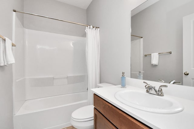 bathroom with vanity, shower / tub combo, and toilet
