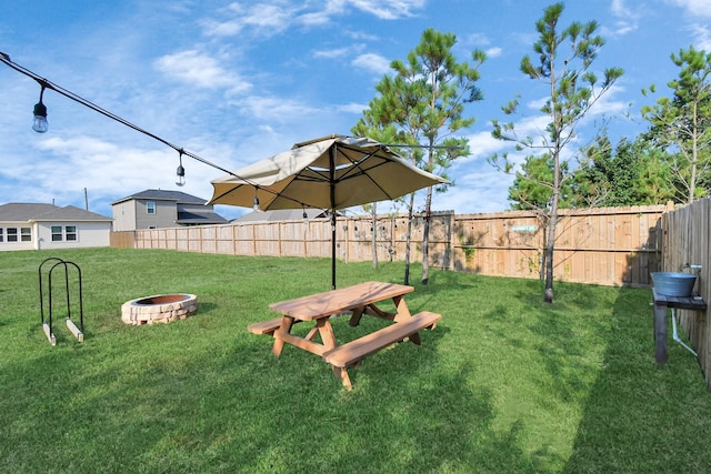 view of yard featuring a fire pit and fence
