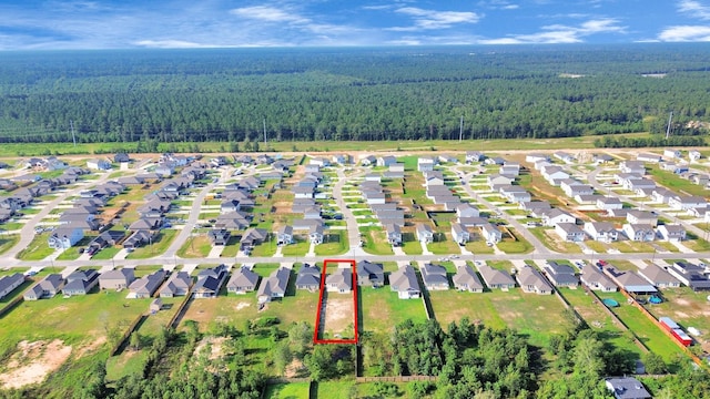 drone / aerial view with a residential view and a view of trees