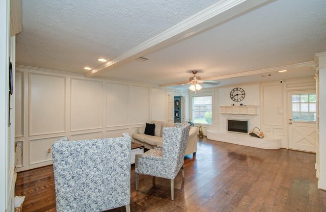 6711 Pebble Beach Dr, Houston, TX 77069 - living room featuring a decorative wall, a textured ceiling, ornamental molding, dark wood-style flooring, and a brick fireplace