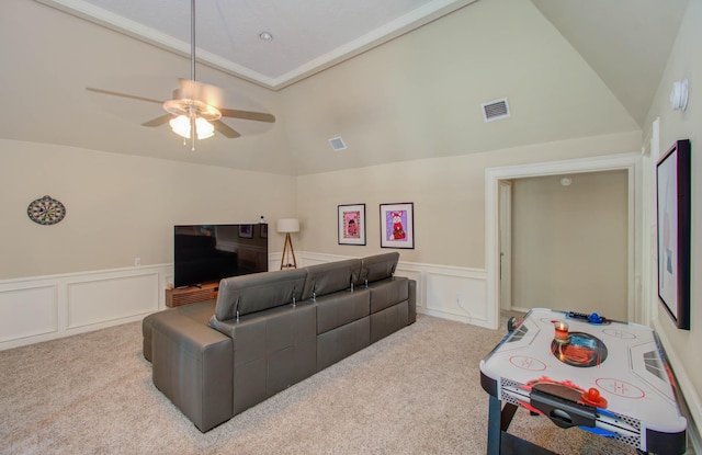 6711 Pebble Beach Dr, Houston, TX 77069 - carpeted living room featuring a decorative wall, vaulted ceiling, a wainscoted wall, and ceiling fan