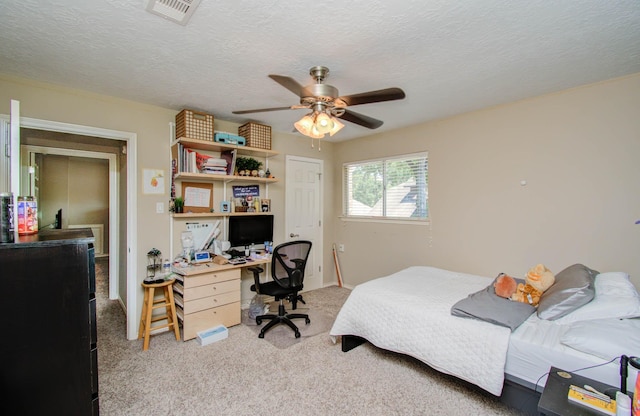6711 Pebble Beach Dr, Houston, TX 77069 - bedroom with light colored carpet, an office area, a ceiling fan, and a textured ceiling