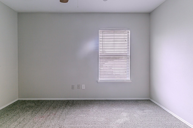 unfurnished room featuring carpet flooring and baseboards