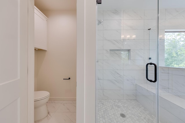 bathroom with baseboards, marble finish floor, a shower stall, and toilet