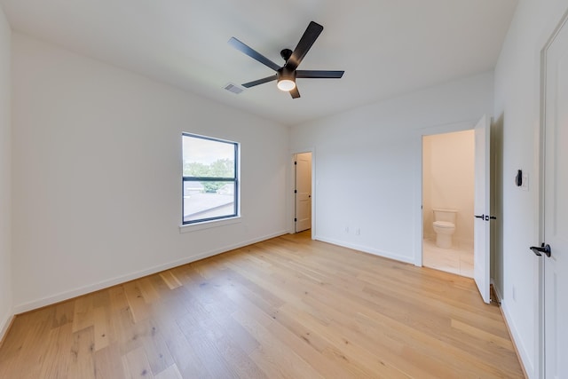 unfurnished bedroom with ensuite bathroom, baseboards, visible vents, light wood-style floors, and ceiling fan
