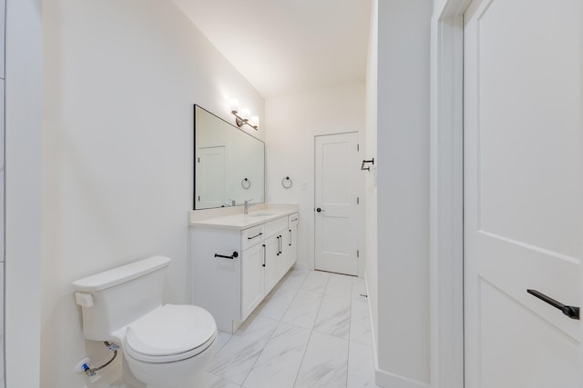 bathroom featuring marble finish floor, vanity, and toilet