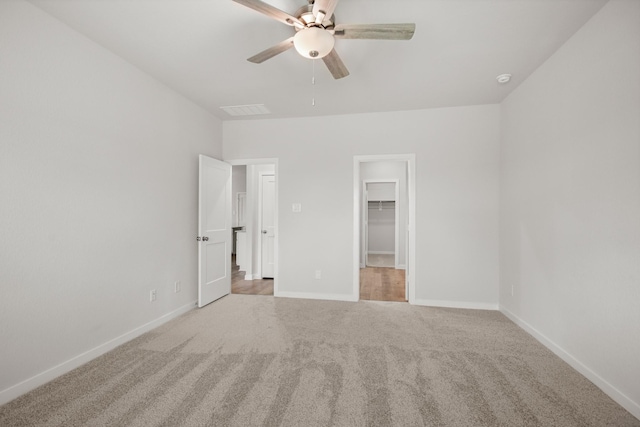 16899 Needlepoint Dr, Conroe, TX 77302 - unfurnished bedroom with carpet floors, a walk in closet, ceiling fan, and a closet