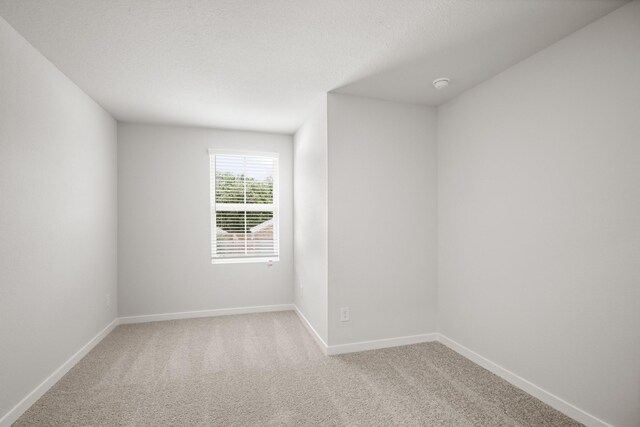 16899 Needlepoint Dr, Conroe, TX 77302 - carpeted spare room with baseboards and a smoke detector