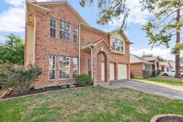 view of front facade featuring driveway, brick siding, a front yard, and a garage