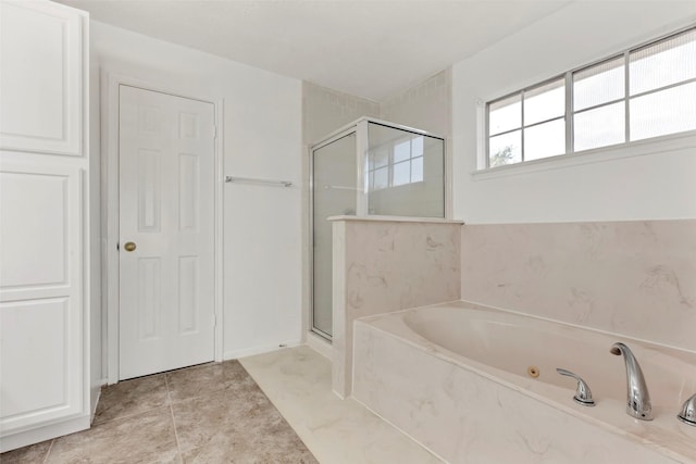 bathroom with tile patterned flooring, a stall shower, and a tub with jets